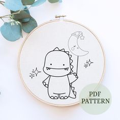 a cross stitch pattern with a cute little dinosaur holding a moon and stars on it