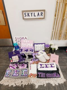 there are many items on the floor in front of the sign that says skylar