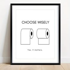 a poster with the words choose wisely and two rolls of toilet paper