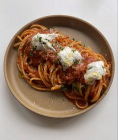 a plate of spaghetti with sauce and parmesan cheese on top, ready to be eaten