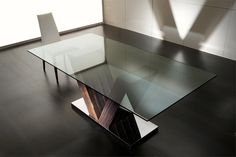 a glass table with two white chairs next to it