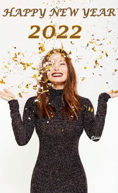 a woman with confetti all over her face and hands in front of her head