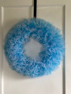 a blue wreath hanging on the front door