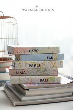 a stack of books sitting on top of each other next to a birdcage