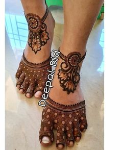 the feet are decorated with henna tattoos