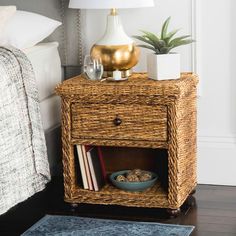 a wicker night stand with a bowl of cereal on it and a lamp next to it