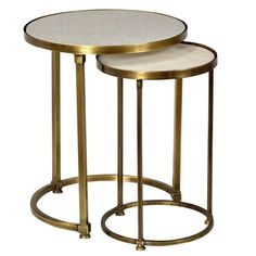 two round tables with gold metal bases and white marble tops, one on each side