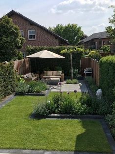 a backyard garden with lawn and patio furniture