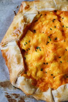 a cheesy pizza sitting on top of a table