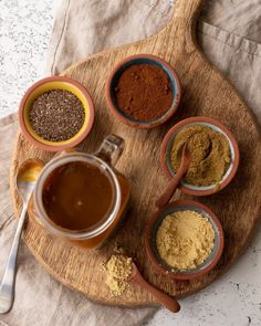 various spices and seasonings in small bowls on a wooden tray