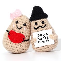 two small crocheted toys with funny faces holding a sign that says you are the mrs to my mr