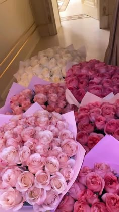 a bunch of pink and white roses are on display