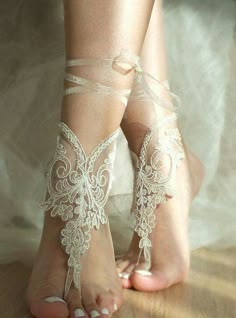 a woman's feet with white lace on them