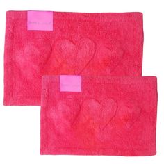 two pink towels with hearts on them