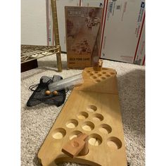 a wooden board game sitting on the floor