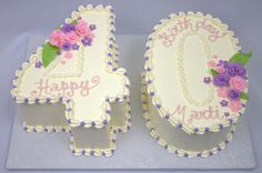 two birthday cakes are decorated with flowers and the number one is made out of frosting