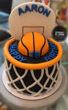 a cake that is decorated to look like a basketball hoop with the name aaron on it