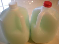 two plastic jugs sitting on top of a counter