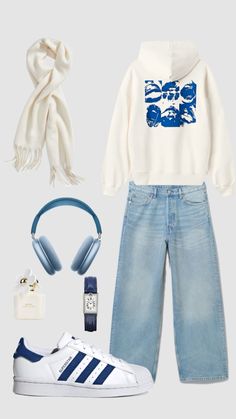 a white sweatshirt, blue jeans and headphones are outfitted with adidas sneakers