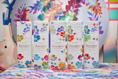 three bars of white chocolate sitting on top of a colorful tablecloth with flowers in the background