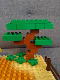 a tree made out of legos sitting on top of a couch