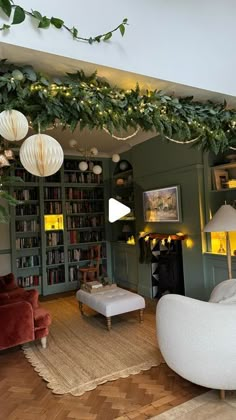 a living room filled with furniture and lots of green plants on the wall above it