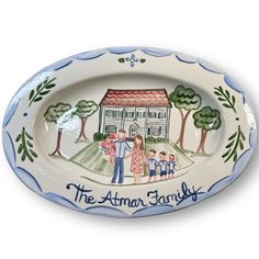 an oval platter with the words, the atmn family painted on it and people standing in front