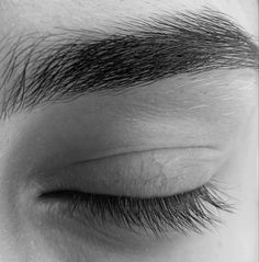 the top part of someone's eye with long, thin hair on their forehead