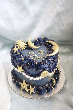 a blue cake with stars and moon decorations