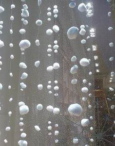 the window is covered with white balls and snowflakes