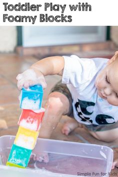 a toddler playing with foam blocks in a play box on the floor and text overlay that says toddler play with foam blocks