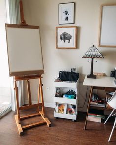 an easel stands next to a whiteboard in a room