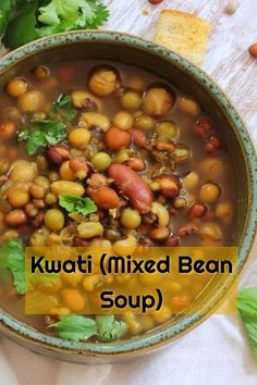 a bowl filled with beans and cilantro on top of a table