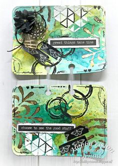 two tags that have been altered to look like they are decorated with flowers and leaves