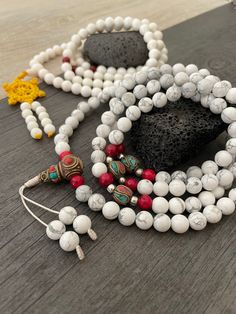 Beautiful Howlite Mala from Nepal and Mountain shell beads Mala necklace. You can choose between the mala that is made with howlite beads (white with gray) and mix metal beads from Nepal, or the all white mala necklace, which is made with mountain shell beads and a yellow mantra symbol. A unique praying mala that can be used as a necklace or as an ornament. The mala has no clasp, you wear it over the head. --The Mala with the metal beads and the red beads has a total length of 48.2cm- 19 inch lo Buddhist Mala, Wiccan Necklace, Yoga Lover Gift, Beads Mala, 108 Mala Beads, Mens Necklace, Hippie Necklace, Red Beads, Yoga Gifts