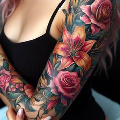 a woman's arm with flowers on it and a black top in the background