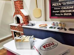 a small pizza oven sitting on top of a counter