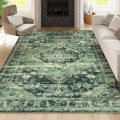 a living room area with couches, chairs and a rug in front of a fireplace