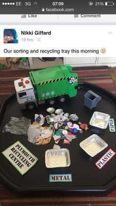 a tray with various items on it and a toy truck in the middle one is green