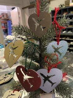 a small christmas tree decorated with paper hearts