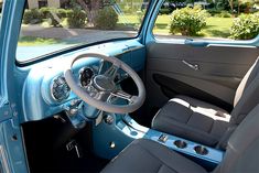 the interior of an old blue truck is clean and ready to be used for driving