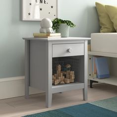 a small white table with a basket on it