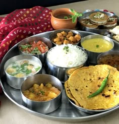 a metal plate topped with lots of different types of food