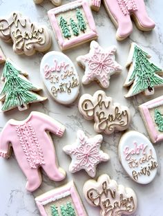 decorated cookies are arranged on a marble surface