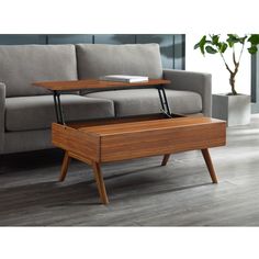 a coffee table with an open drawer on it in the middle of a living room