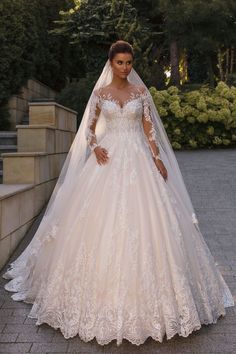 a woman in a wedding dress posing for the camera