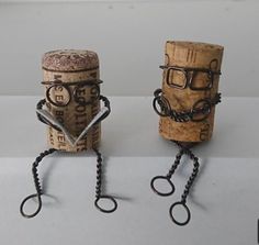 two wine corks with eye glasses on them