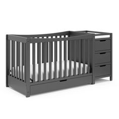 a gray crib with two drawers and a white sheet on the bottom bed, in front of a white background