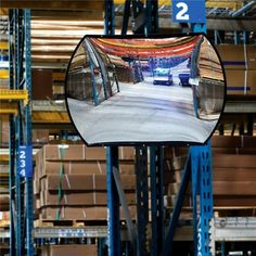 there is a large mirror in the middle of a warehouse