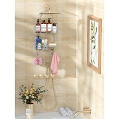 a bathroom with a sink, shower head and shelves on the wall